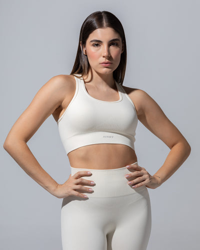 SEAMLESS RIBBED SUNSET BRA TOP — CREAM