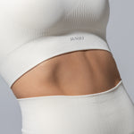 SEAMLESS RIBBED SUNSET BRA TOP — CREAM