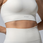 SEAMLESS RIBBED SUNSET BRA TOP — CREAM